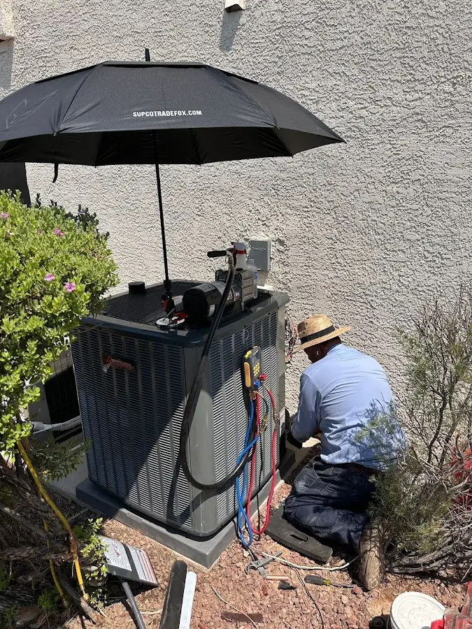 HVAC technician performing outdoor AC maintenance in Somerset